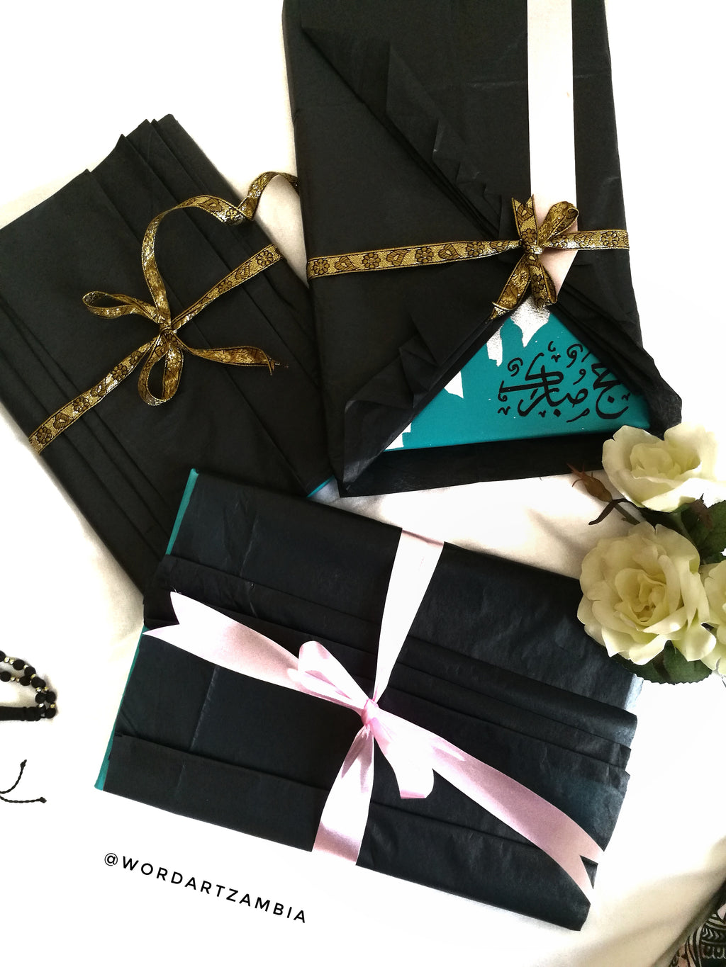 Black gift bags with ribbons on a white background