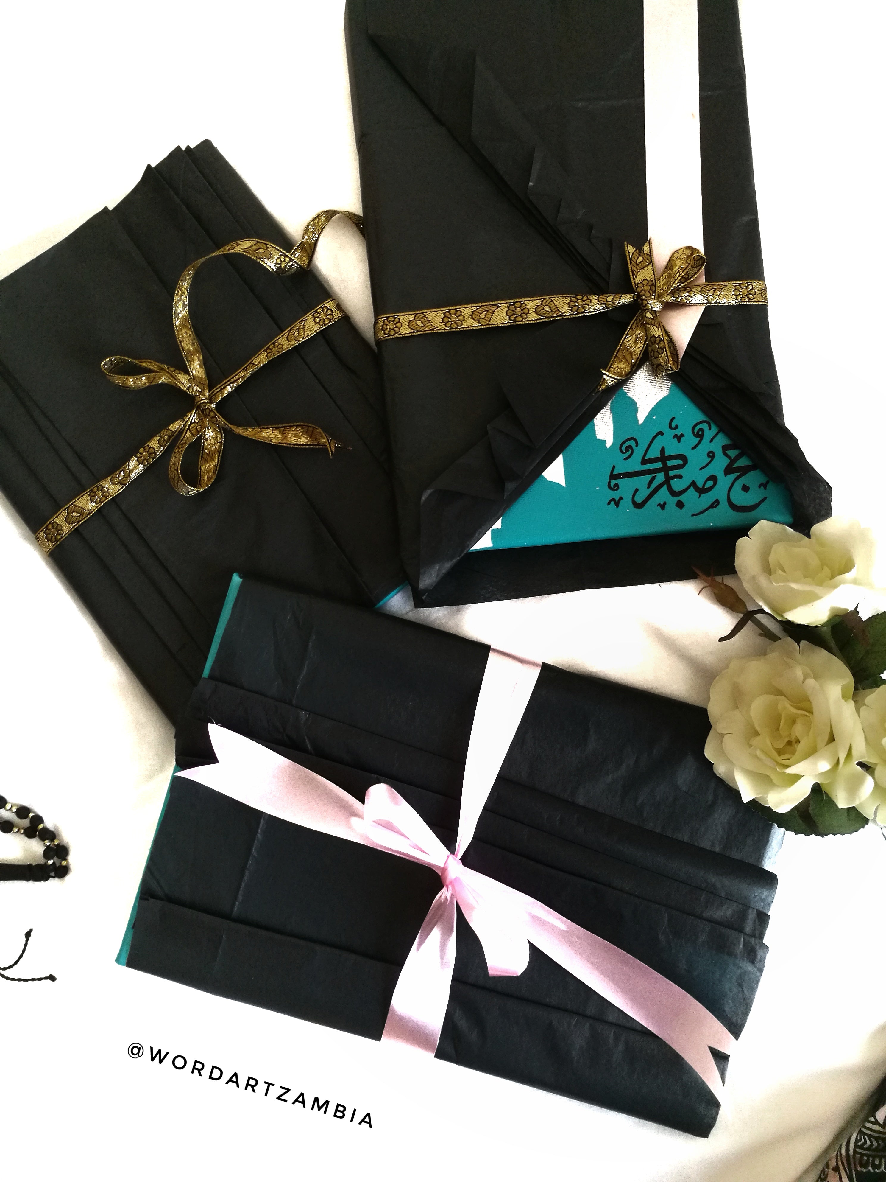 Black gift bags with ribbons on a white background