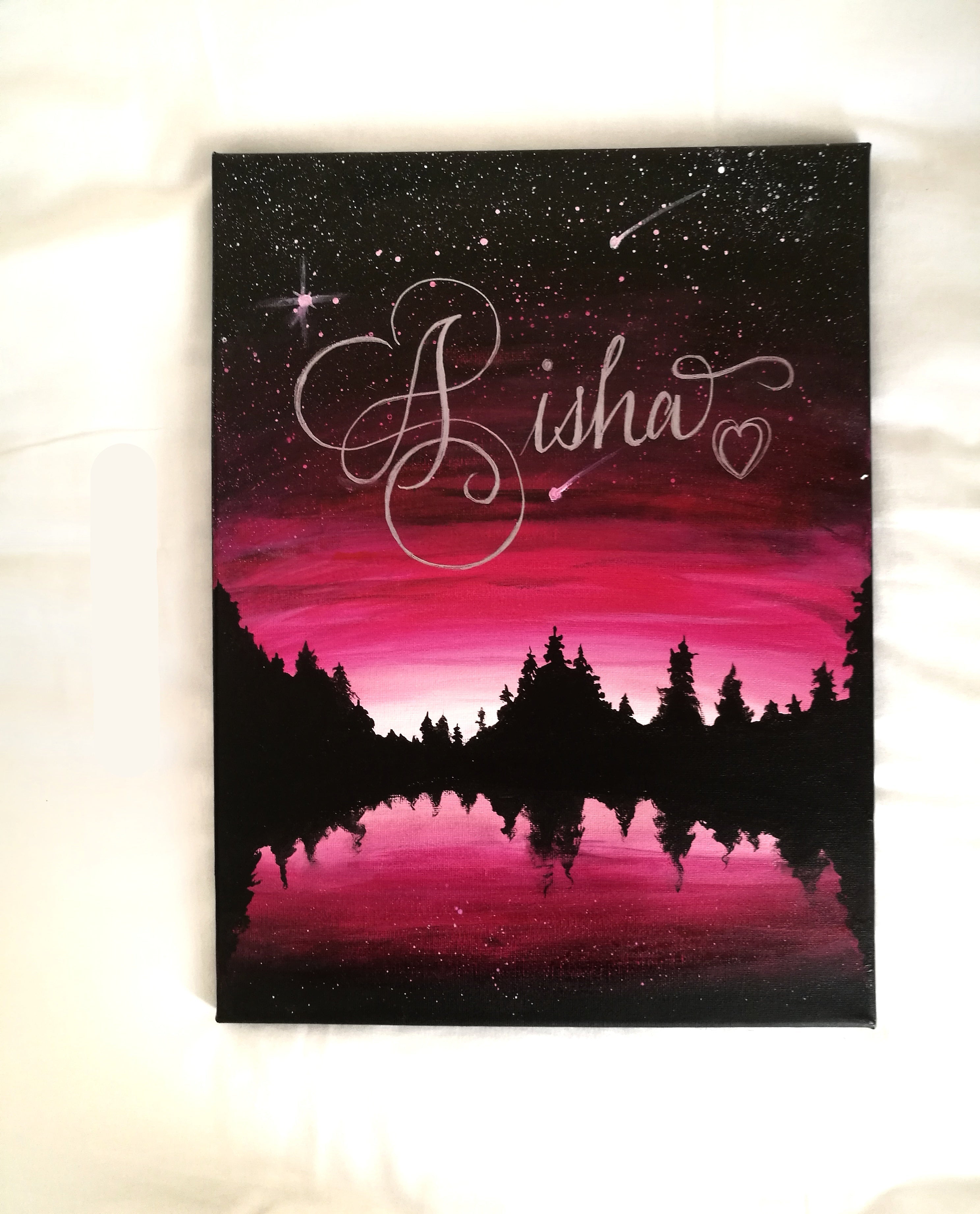 Canvas print with a pink and purple sky, trees, and the name 'Aisha' in cursive.